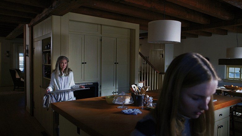 (L to R) Nana (DEANNA DUNAGAN) needs Becca’s (OLIVIA DEJONGE) help cleaning the oven in Universal Pictures’ “The Visit”. Writer/director/ producer M. Night Shyamalan returns to his roots with the terrifying story of a brother and sister who are sent to th
