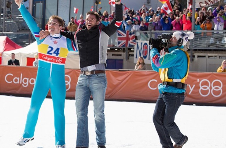 Eddie (Taron Egerton) and his coach Bronson Peary (Hugh Jackman) rejoice in Eddie’s triumph. Larry Horricks – TM and © 2015 Twentieth Century Fox Film Corporation. All Rights Reserved. Not for sale or duplication.