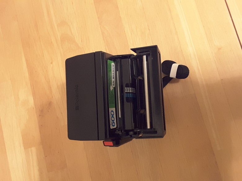 Open the film door with the arrow on the right side