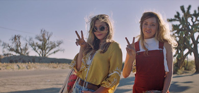 Ingrid (Aubrey Plaza) and Taylor (Elizabeth Olsen) pose for a photo in INGRID GOES WEST, courtesy of NEON