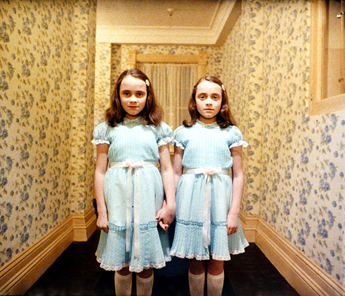 The Shining, directed by Stanley Kubrick (1980; GB/United States). The daughters of former caretaker Grady (Lisa and Louise Burns). © Warner Bros. Entertainment Inc.