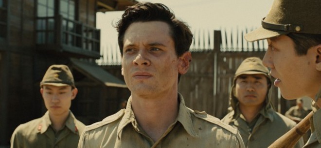 (L to R, foreground) Louis “Louie” Zamperini (JACK O’CONNELL) is tormented by The Bird (MIYAVI) in “Unbroken”, an epic drama that follows the incredible life of Olympian and war hero Zamperini. Photo Credit: Universal Pictures Copyright: © 2014 Universal 